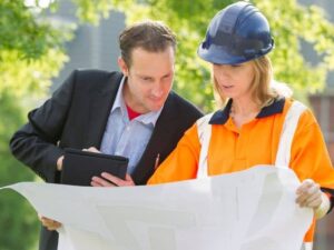 Homeowner reviewing a property survey with a land surveying professional.