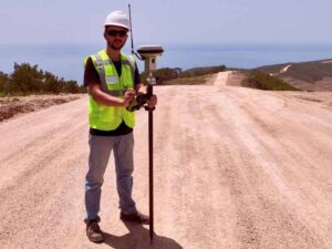 Surveyor using GNSS equipment on remote desert acreage with rough road access in Laughlin Nevada.